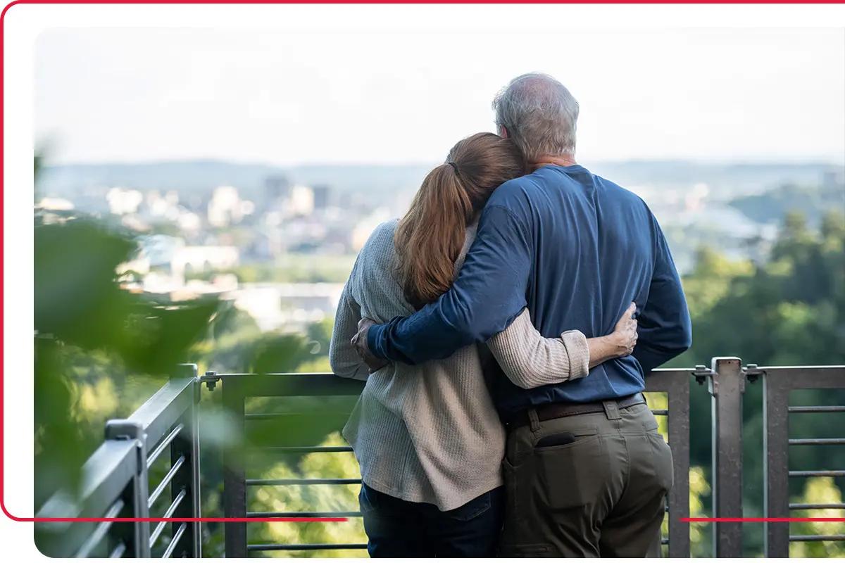 Older couple hugging while overlooking Tennessee city