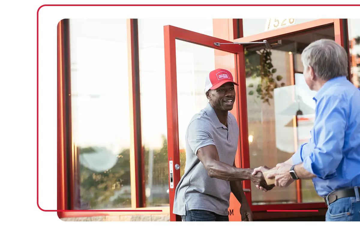 Farm Bureau Insurance of Tennessee insurance agent shaking hands with man outside of business