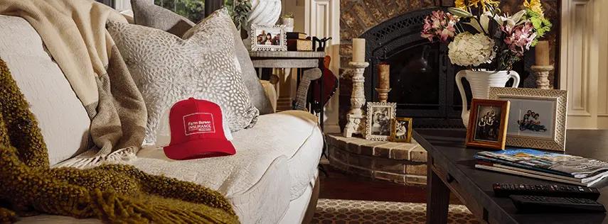 Farm Bureau Insurance of Tennessee red hat sitting on couch in living room of family home