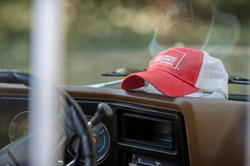 Farm Bureau Insurance of Tennessee red hat sitting on the dashboard of an old truck
